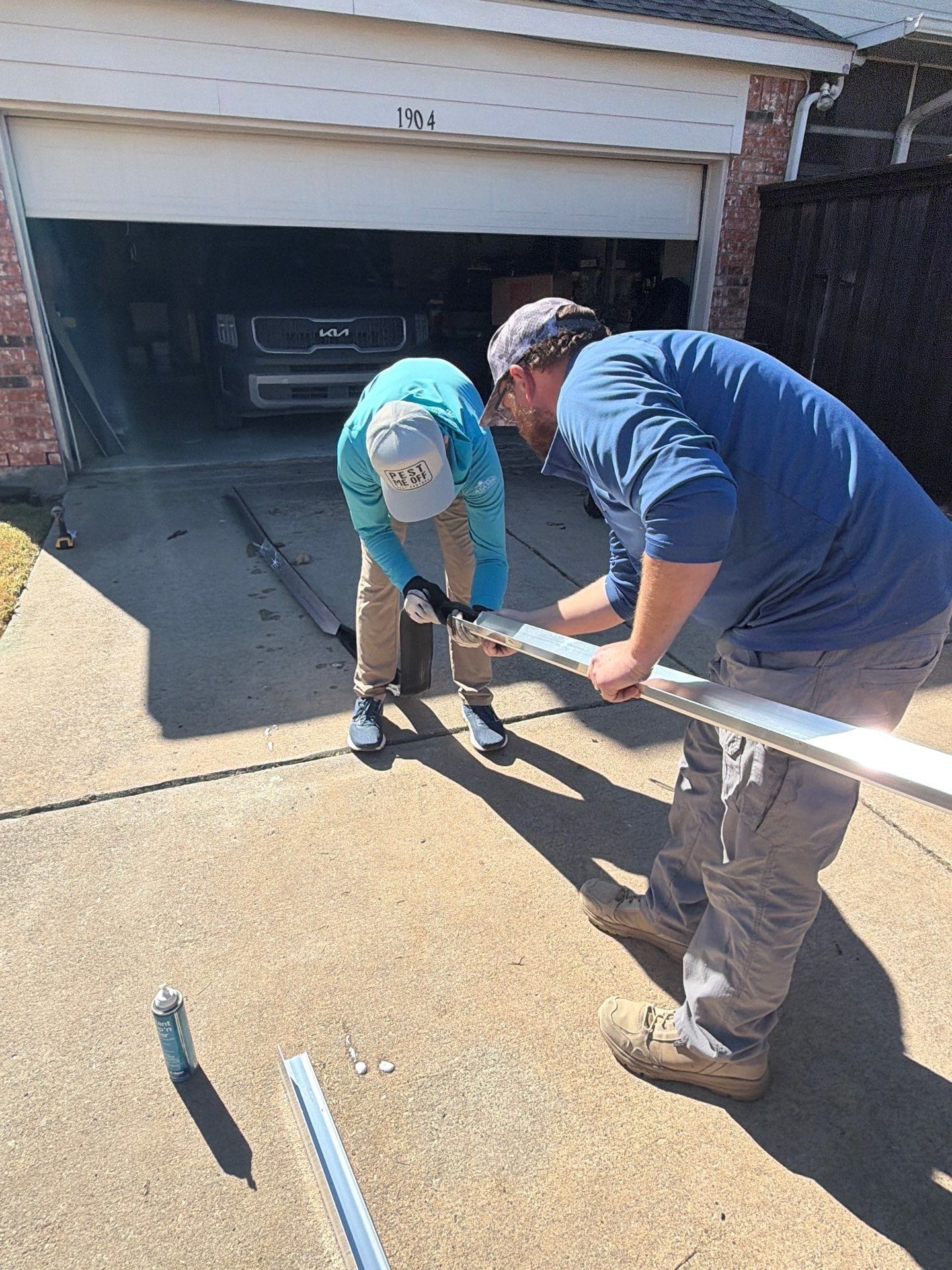 Technicians installing exclusion barrier on garage to prevent rodent entry in Allen