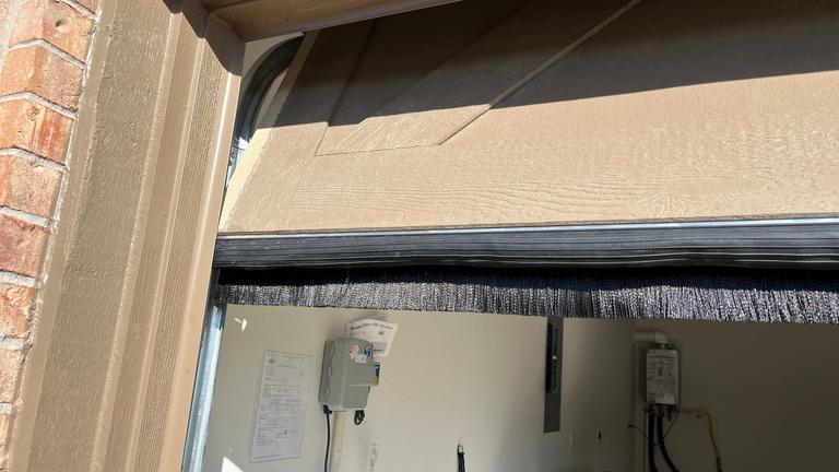 Exclusion work sealing a garage door in McKinney, Texas.