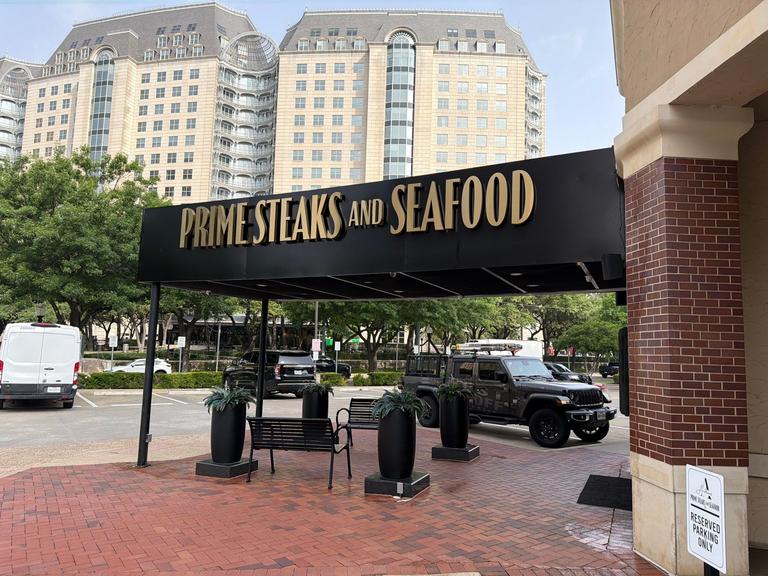 Exterior area of a restaurant entrance with canopy and planters during a rodent-focused preventive inspection in McKinney, Texas.