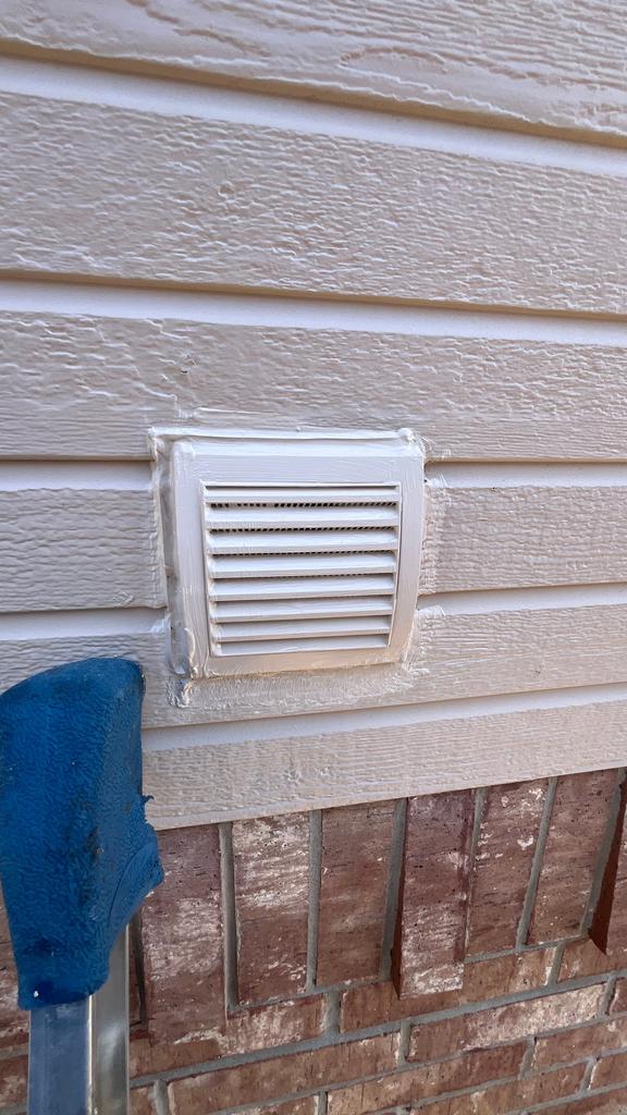Freshly installed, caulked dryer vent cover on an exterior wall, sealing a former rodent entry point at a residence in The Colony, Texas.