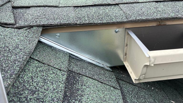 Exclusion work with metal flashing near a roofline in McKinney, Texas.