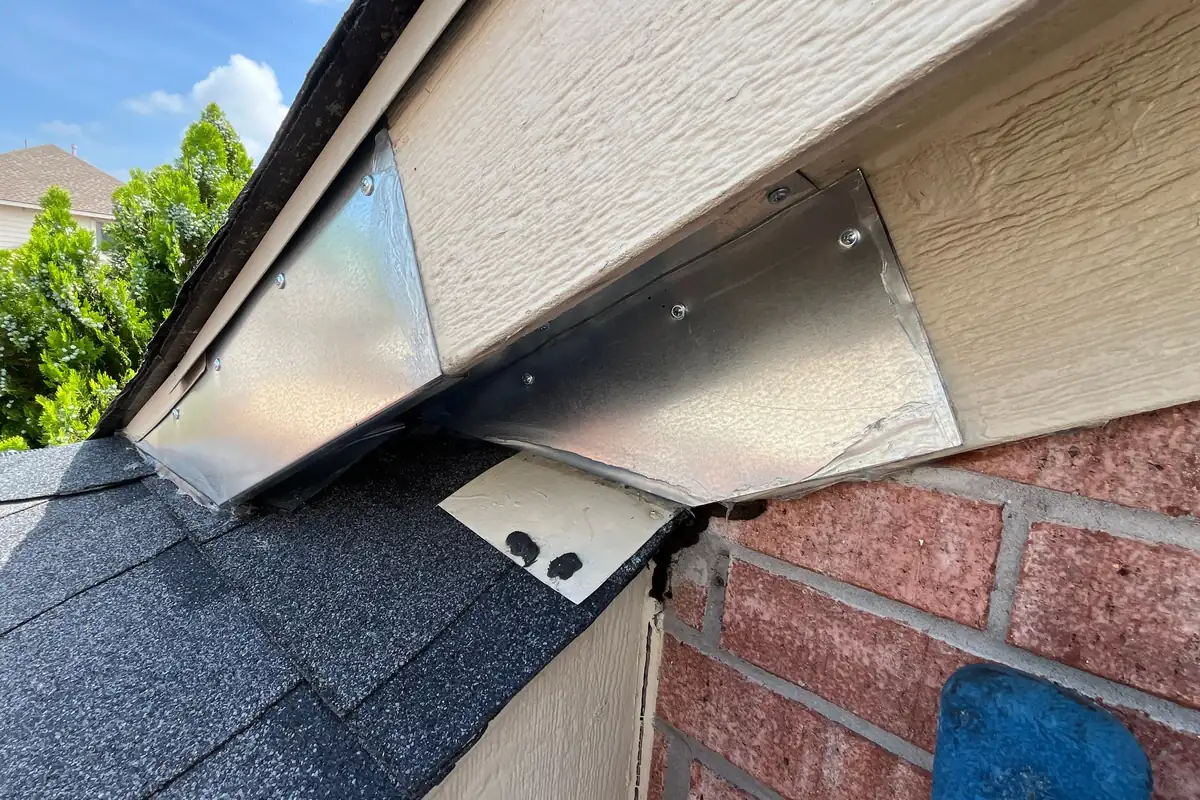 Pest Control Anna, TX 15 Roof-to-brick gap sealed with galvanized steel flashing on a Pest Me Off job in McKinney, TX