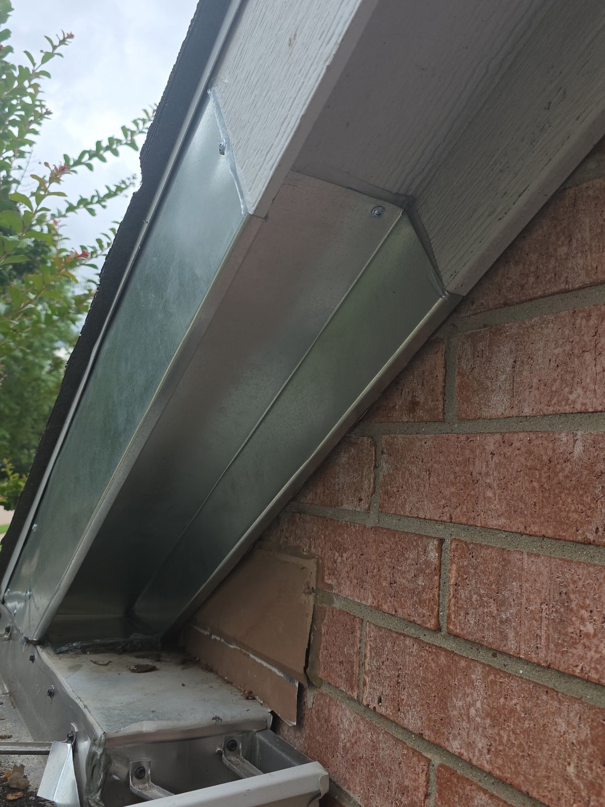 The same Frisco TX roofline gap sealed shut with metal after the animal was removed