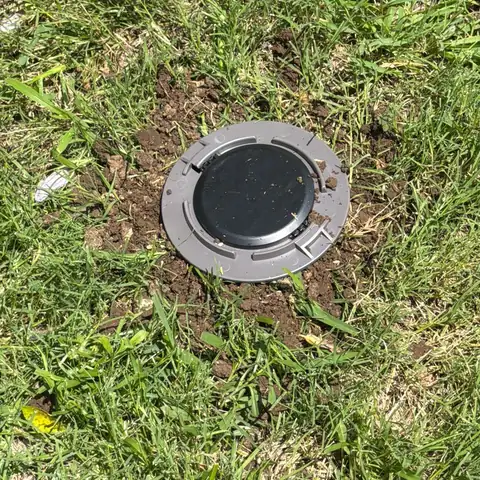 In-ground termite bait station installed in a McKinney TX lawn